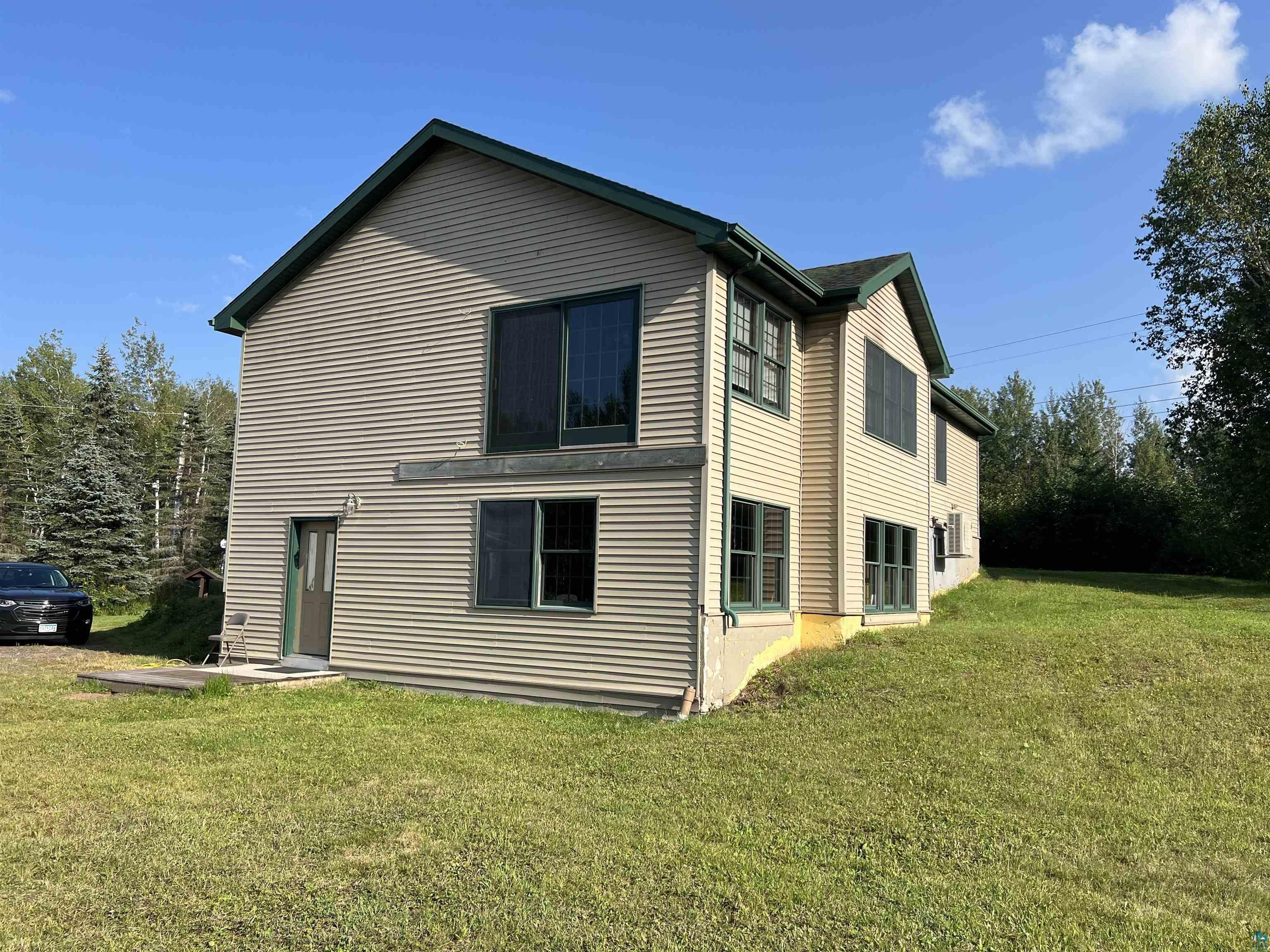 149 Erickson Road Esko, MN 55733 - Photo 2 of 17 Rear view of house featuring a lawn