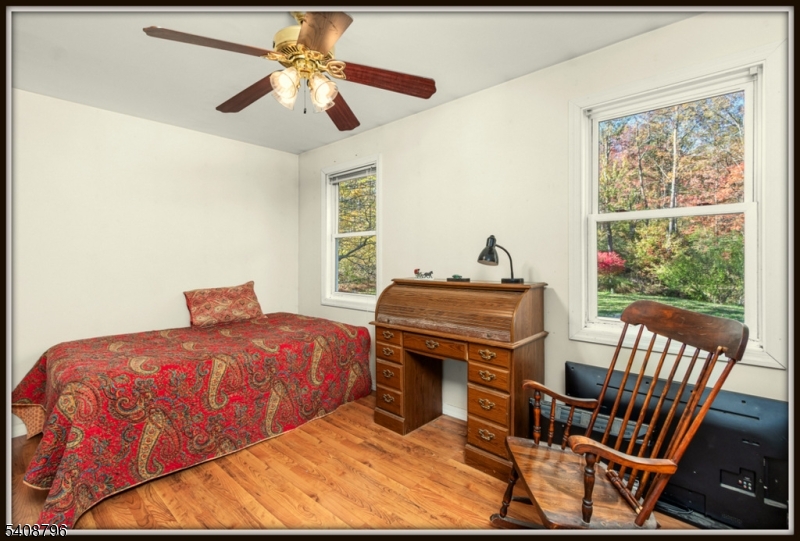 3 Sleepy Hollow Road Newton, NJ 07860 - Photo 17 of 25 a bedroom with a bed and a chandelier