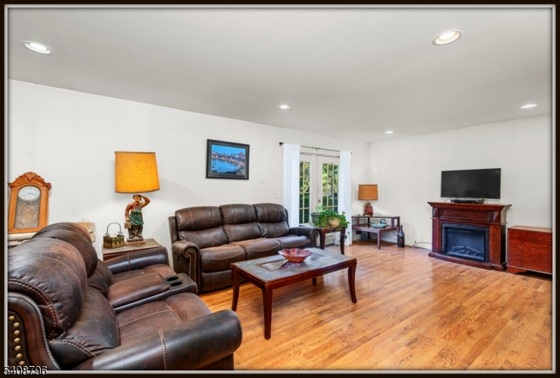 3 Sleepy Hollow Road Newton, NJ 07860 - Photo 6 of 25 a living room with furniture a flat screen tv and a fireplace