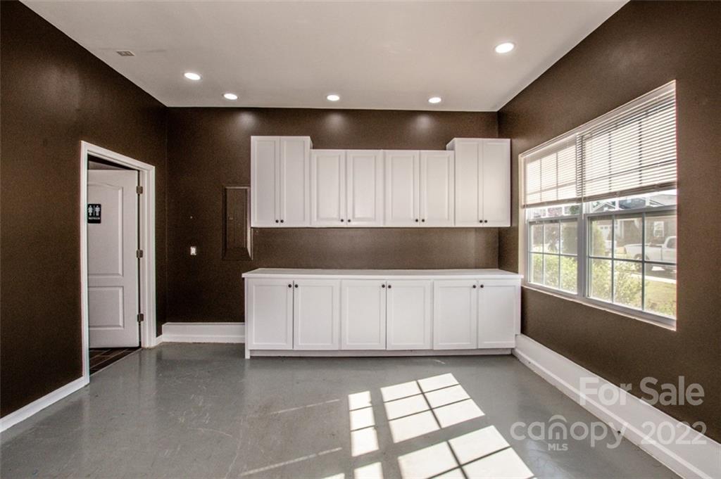 107 East Neel Ranch Road Mooresville, NC 28115 - Photo 22 of 48 a kitchen with granite countertop white cabinets and window