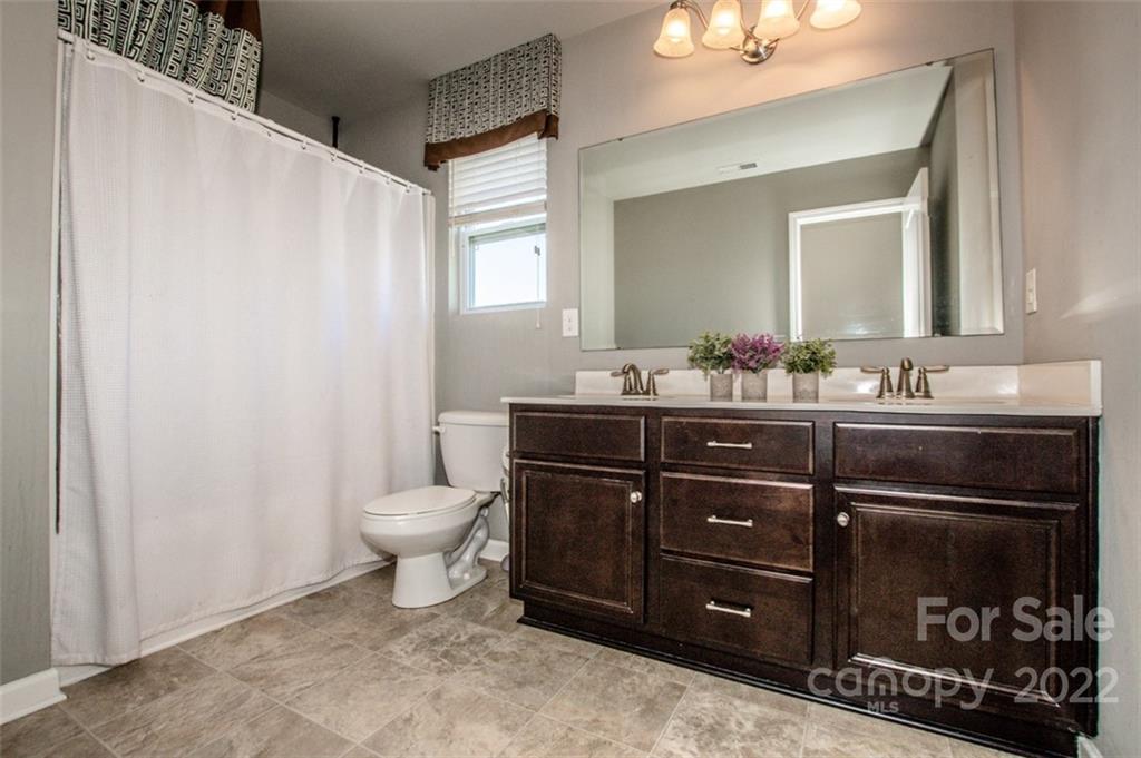 107 East Neel Ranch Road Mooresville, NC 28115 - Photo 31 of 48 a bathroom with a sink vanity and a mirror