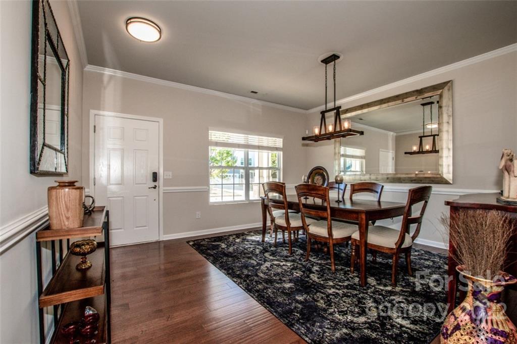 107 East Neel Ranch Road Mooresville, NC 28115 - Photo 4 of 48 a dining room with furniture a chandelier and wooden floor