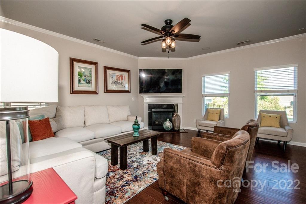 107 East Neel Ranch Road Mooresville, NC 28115 - Photo 7 of 48 a living room with furniture a flat screen tv and a window