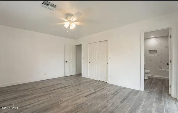 a view of an empty room with wooden floor