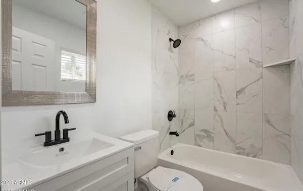 a bathroom with a sink a toilet and bathtub