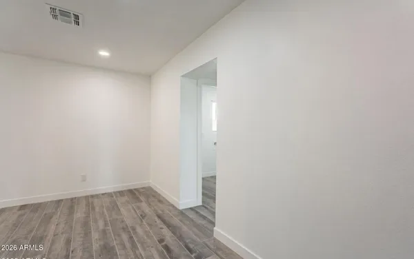 a view of a small space with wooden floor and closet