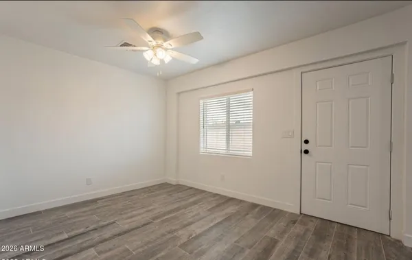 wooden floor in an empty room with a window