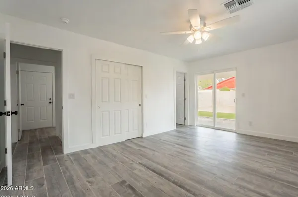 a view of an empty room with wooden floor