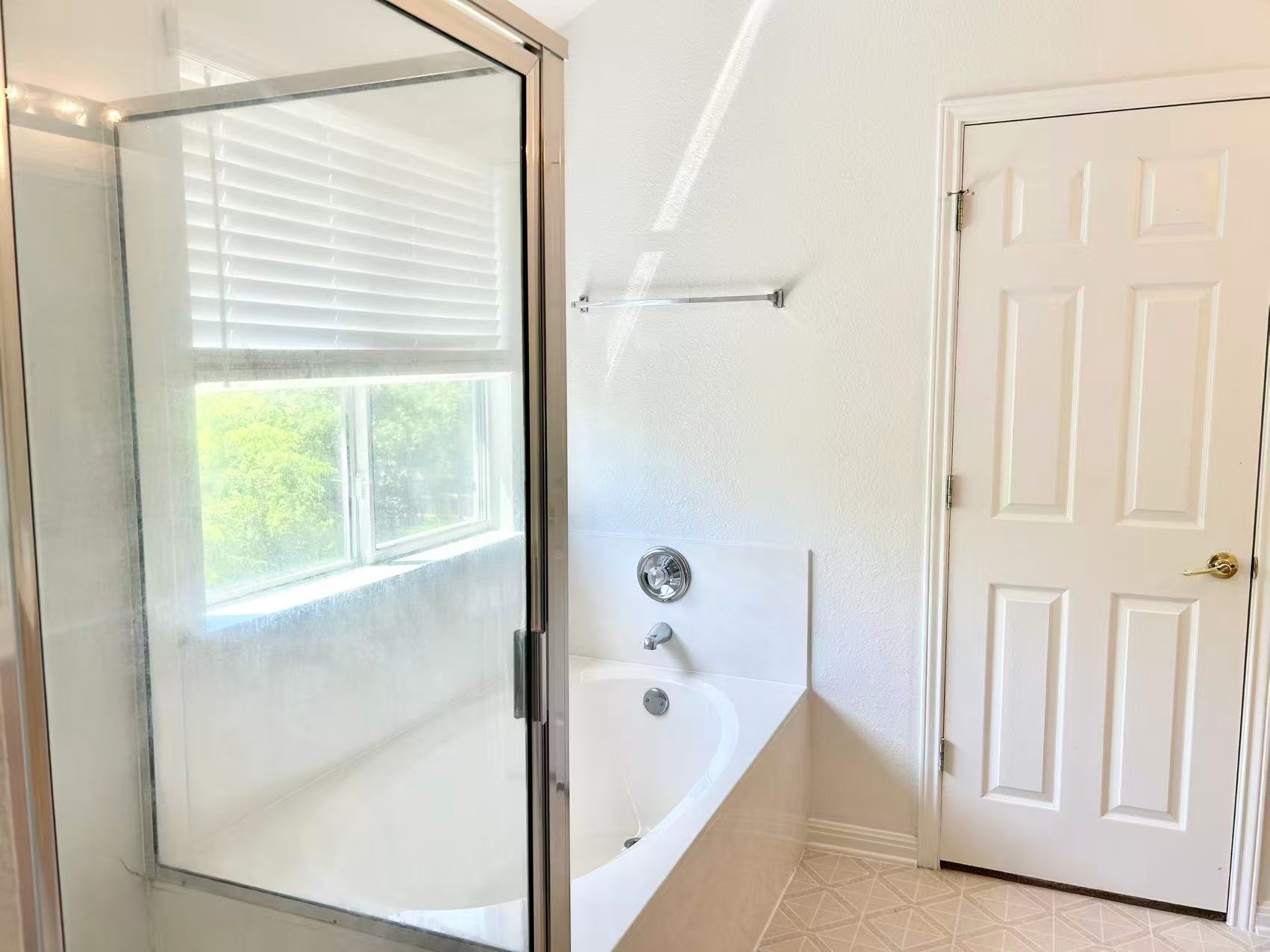 5608 Netleaf Road Austin, TX 78724 - Photo 20 of 26 A well-lit bathroom provides a comfortable bath and shower combination for relaxation.