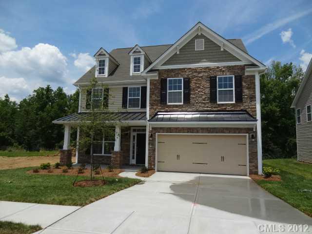 79115 Ridgehaven Road, Unit 161 Lancaster, SC 29720 - Photo 1 of 8 a front view of a house with a yard and garage