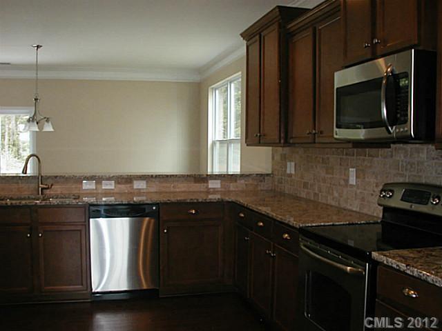 79115 Ridgehaven Road, Unit 161 Lancaster, SC 29720 - Photo 3 of 8 a kitchen with a sink stove and microwave