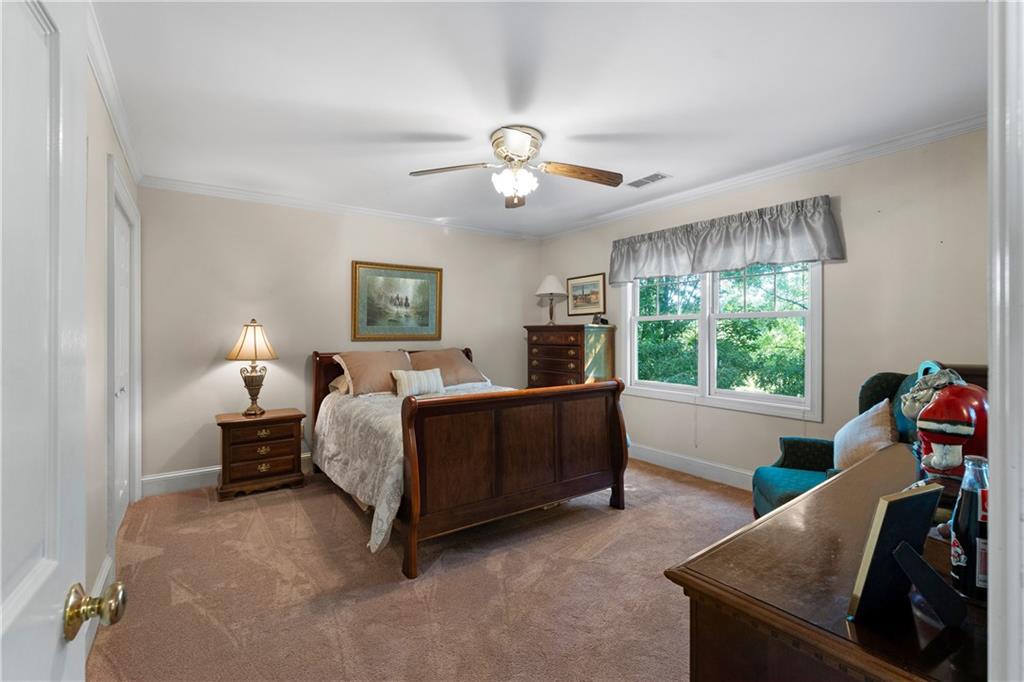 24 Commerce Row Northeast Cartersville, GA 30121 - Photo 22 of 37 a bed room with a bed and a window