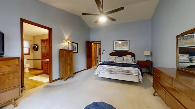 a bedroom with a bed and a view of bedroom