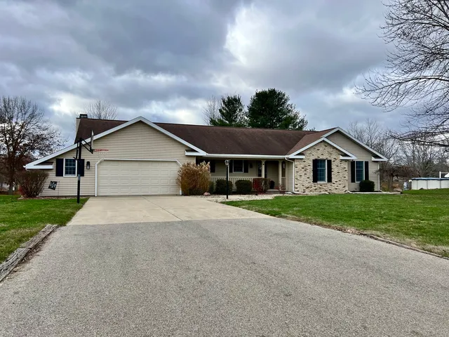 a yellow and white house with a yard