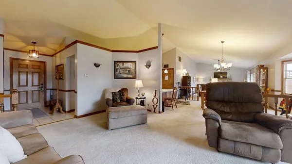 a living room with furniture and a chandelier