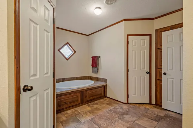 a bedroom with a bed and a mirror