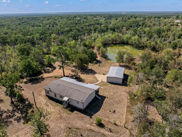 an aerial view of a house with a yard