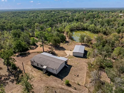 an aerial view of a house with a yard