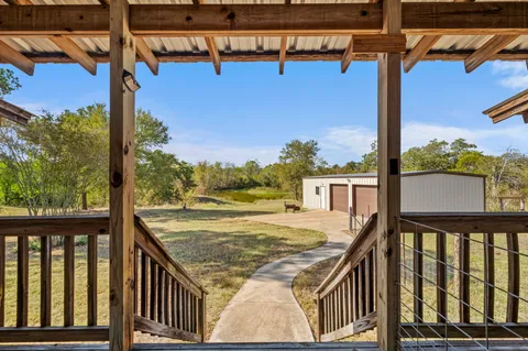 a view of a balcony with chair and wooden floor