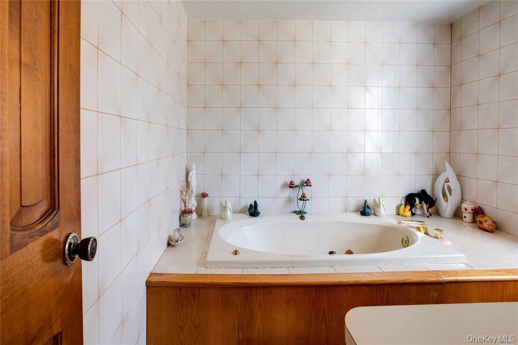 2-44 149th Street Queens, NY 11357 - Photo 12 of 20 a bathroom with a sink and a tub