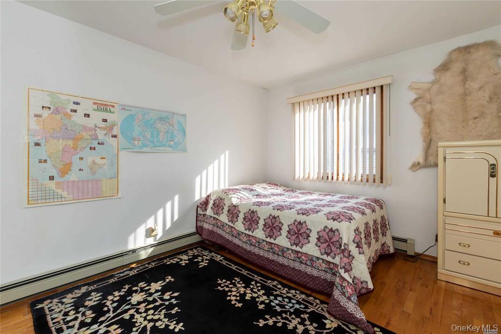 2-44 149th Street Queens, NY 11357 - Photo 15 of 20 a bedroom with a bed and a window