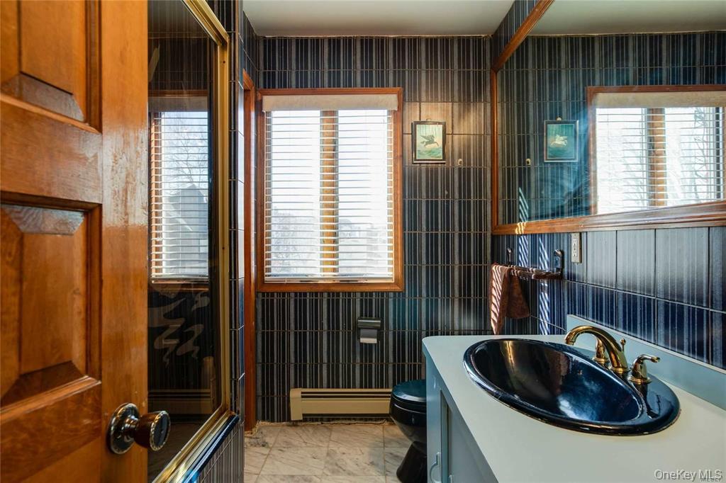 2-44 149th Street Queens, NY 11357 - Photo 17 of 20 a kitchen that has a sink and a window