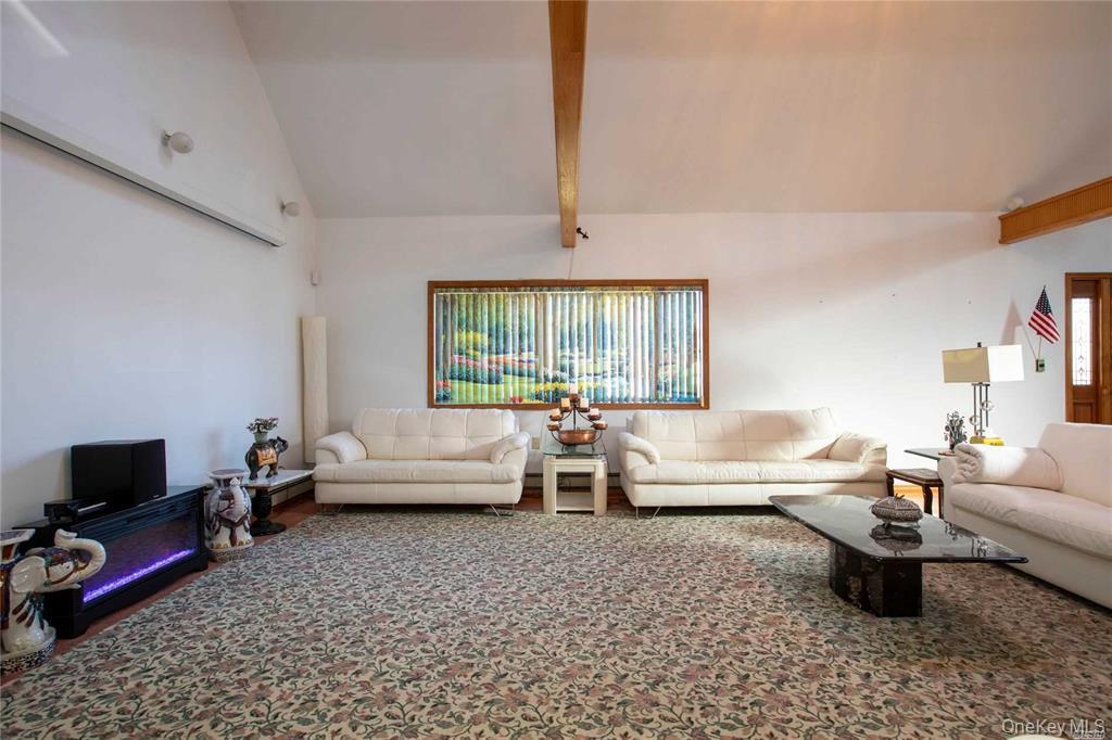 2-44 149th Street Queens, NY 11357 - Photo 3 of 20 a living room with furniture and a flat screen tv