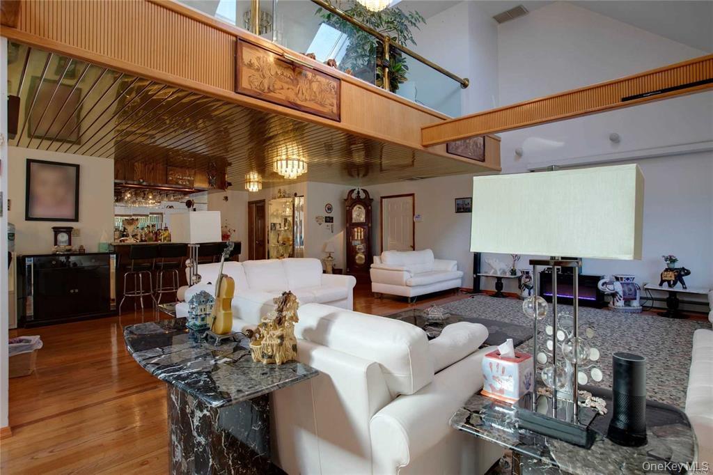 2-44 149th Street Queens, NY 11357 - Photo 5 of 20 a living room with furniture and wooden floor