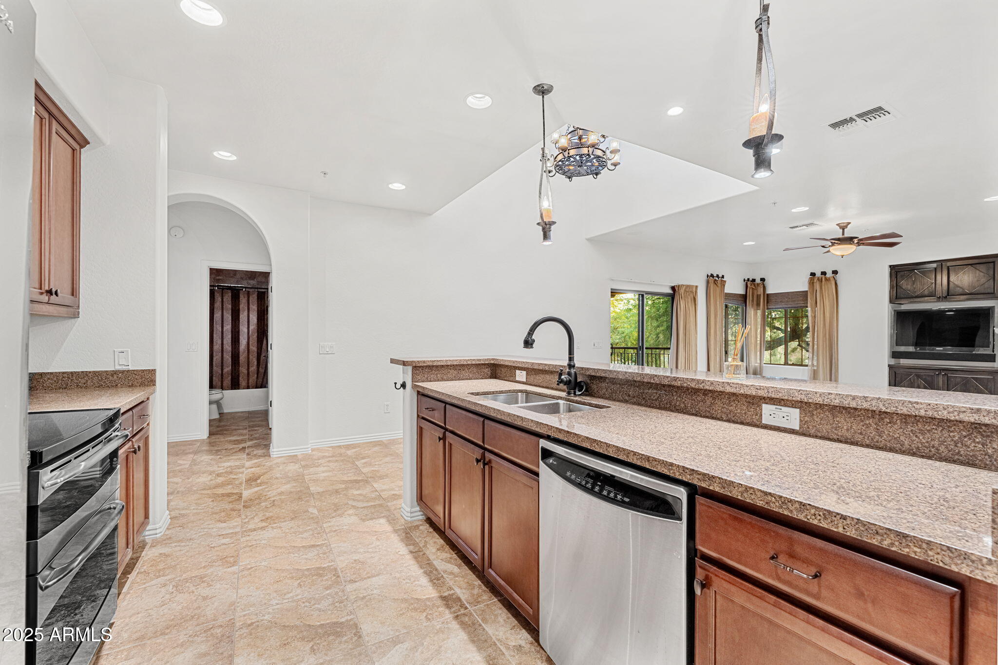 3935 East Rough Rider Road, Unit 1235 Phoenix, AZ 85050 - Photo 13 of 52 a kitchen with stainless steel appliances granite countertop a sink and stove