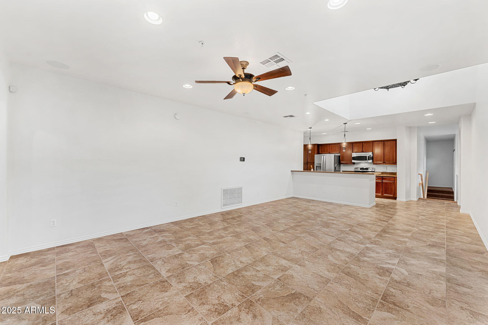 3935 East Rough Rider Road, Unit 1235 Phoenix, AZ 85050 - Photo 14 of 52 a view of a kitchen with a sink and a chandelier fan