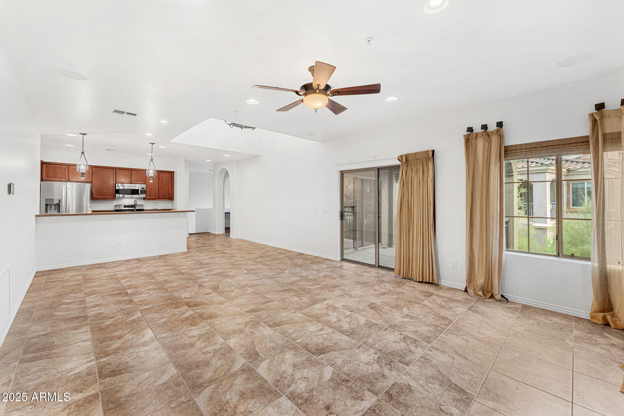 3935 East Rough Rider Road, Unit 1235 Phoenix, AZ 85050 - Photo 16 of 52 a view of a kitchen with furniture and a ceiling fan