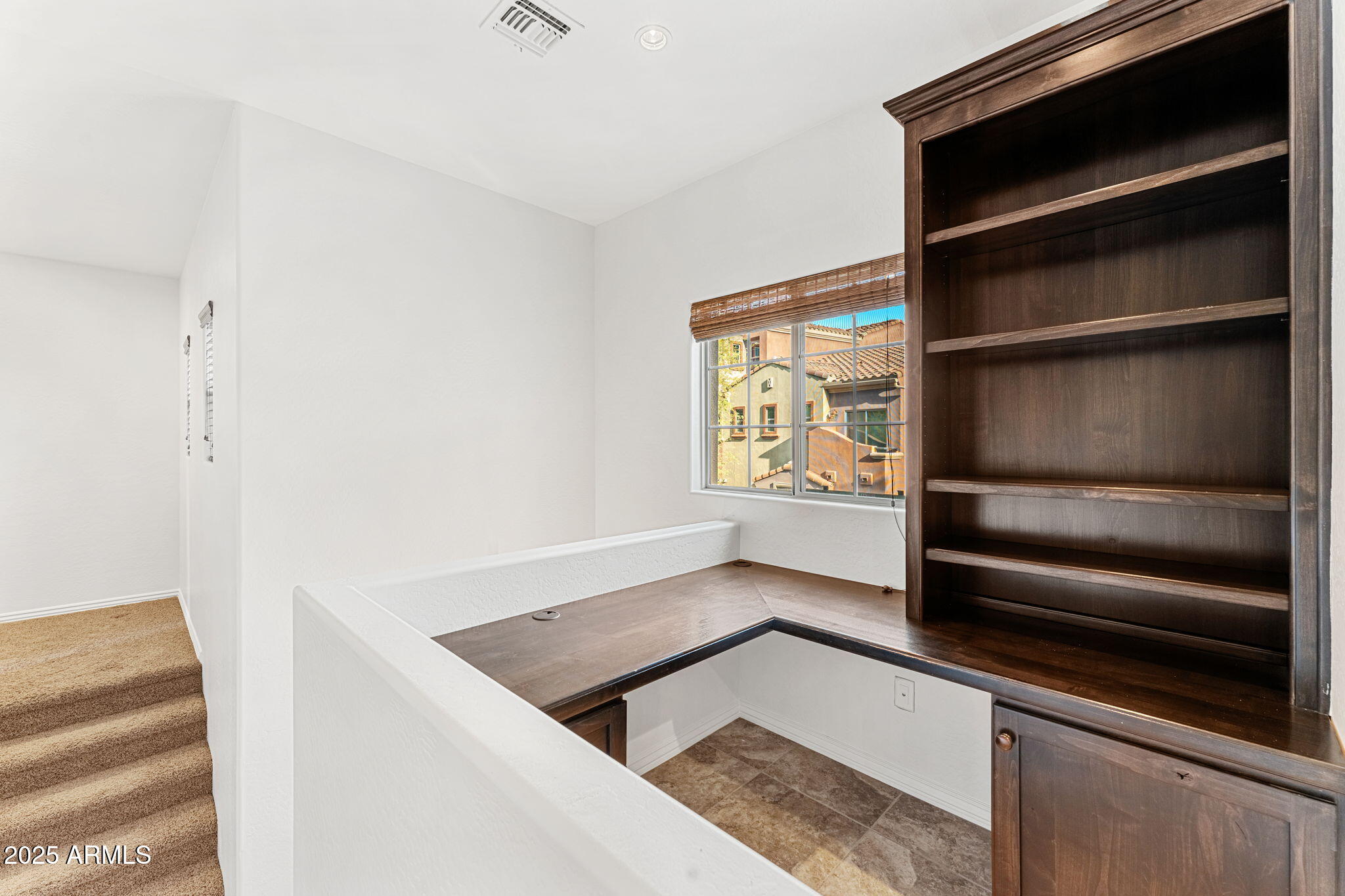3935 East Rough Rider Road, Unit 1235 Phoenix, AZ 85050 - Photo 17 of 52 a kitchen with white cabinets and a wooden floor