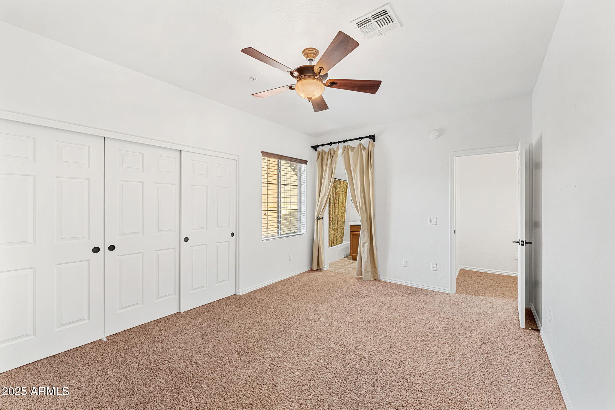 3935 East Rough Rider Road, Unit 1235 Phoenix, AZ 85050 - Photo 21 of 52 a view of a livingroom with a ceiling fan and window