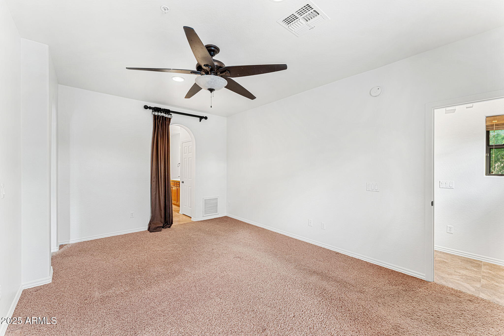 3935 East Rough Rider Road, Unit 1235 Phoenix, AZ 85050 - Photo 27 of 52 a view of a room with a ceiling fan