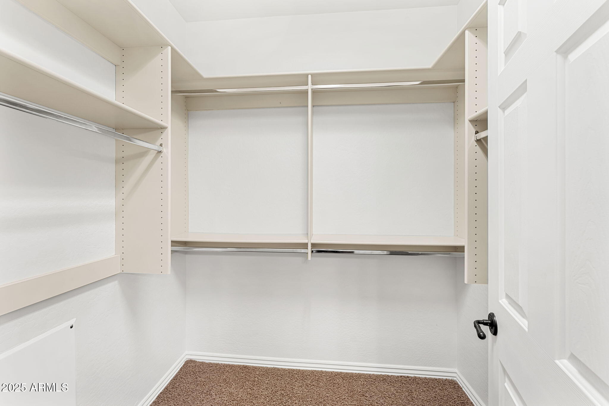 3935 East Rough Rider Road, Unit 1235 Phoenix, AZ 85050 - Photo 34 of 52 a view of an empty walk in closet