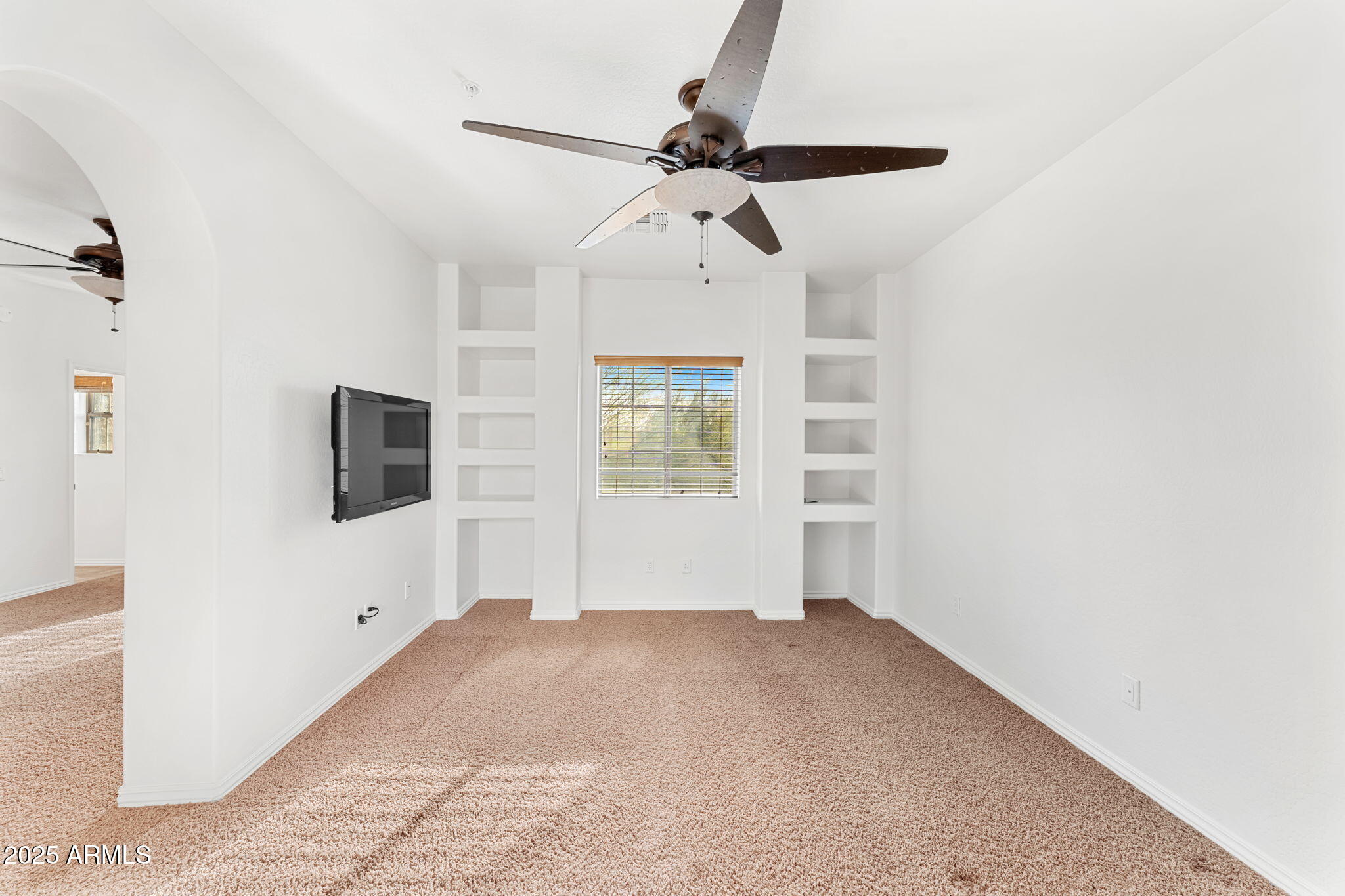3935 East Rough Rider Road, Unit 1235 Phoenix, AZ 85050 - Photo 35 of 52 a view of a livingroom with a ceiling fan and window