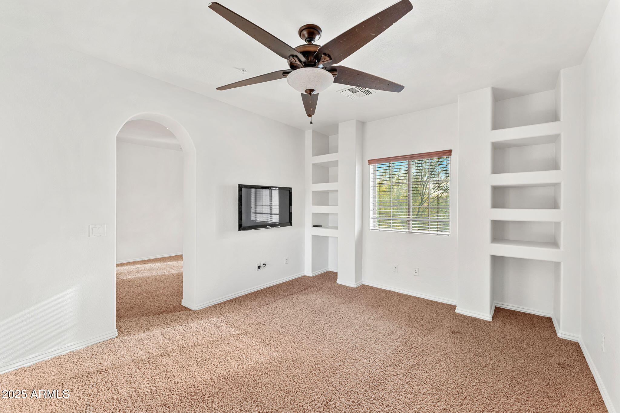 3935 East Rough Rider Road, Unit 1235 Phoenix, AZ 85050 - Photo 37 of 52 a view of a livingroom with a ceiling fan and window