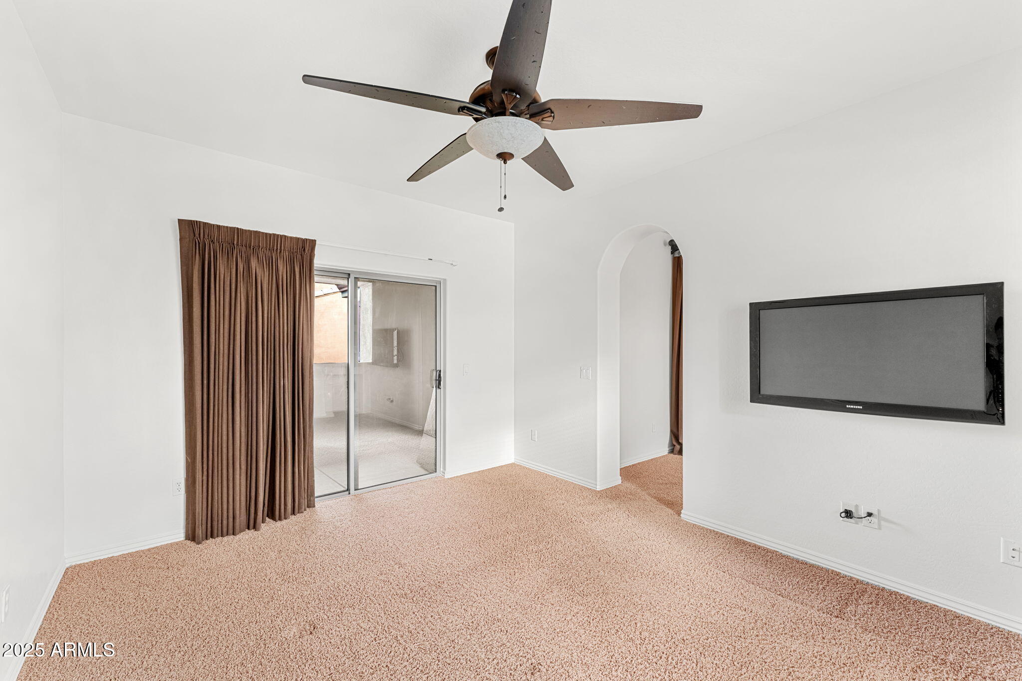 3935 East Rough Rider Road, Unit 1235 Phoenix, AZ 85050 - Photo 39 of 52 a bedroom with a bed and a flat screen tv