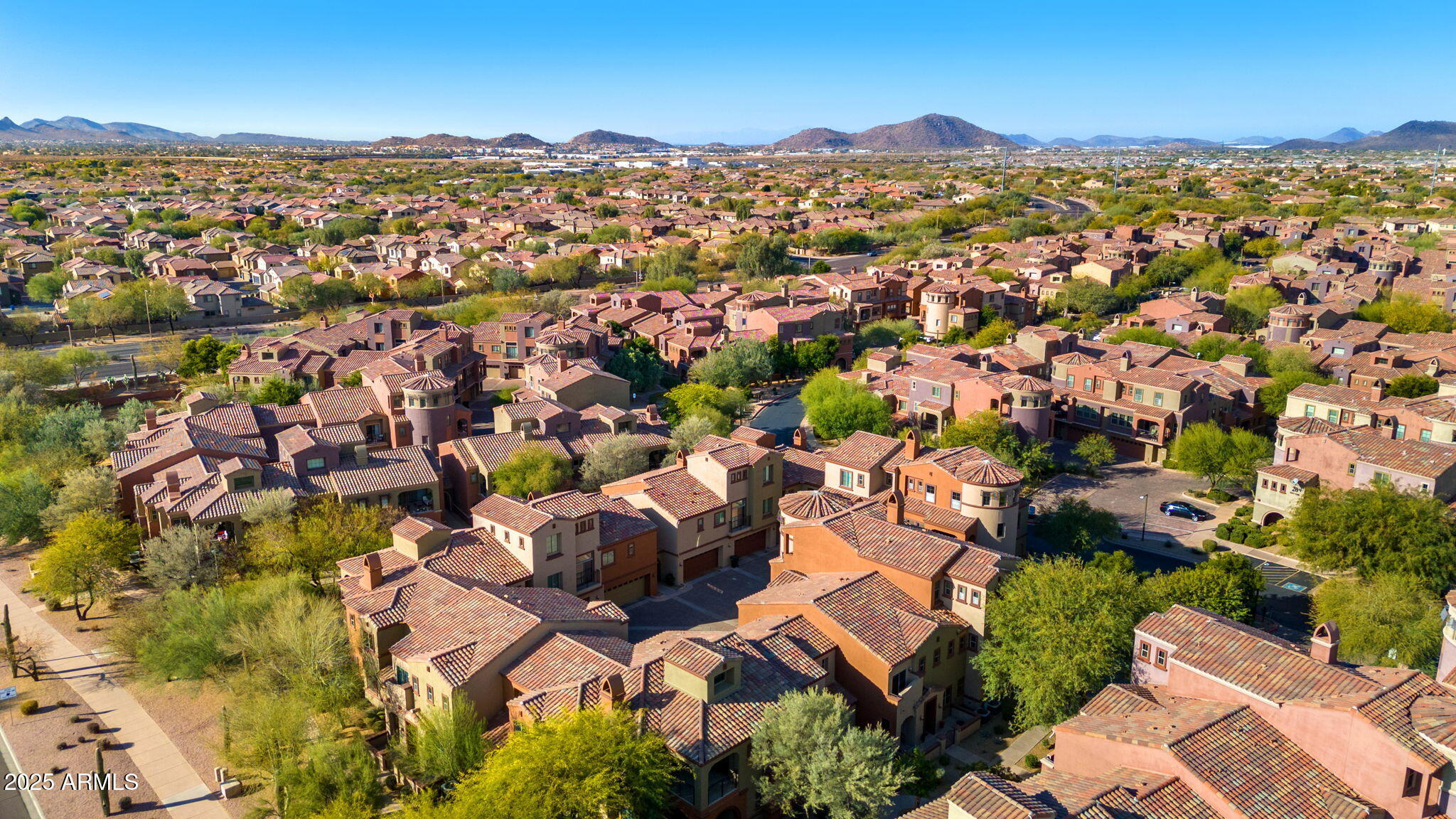 3935 East Rough Rider Road, Unit 1235 Phoenix, AZ 85050 - Photo 48 of 52 an aerial view of residential houses with outdoor space and trees