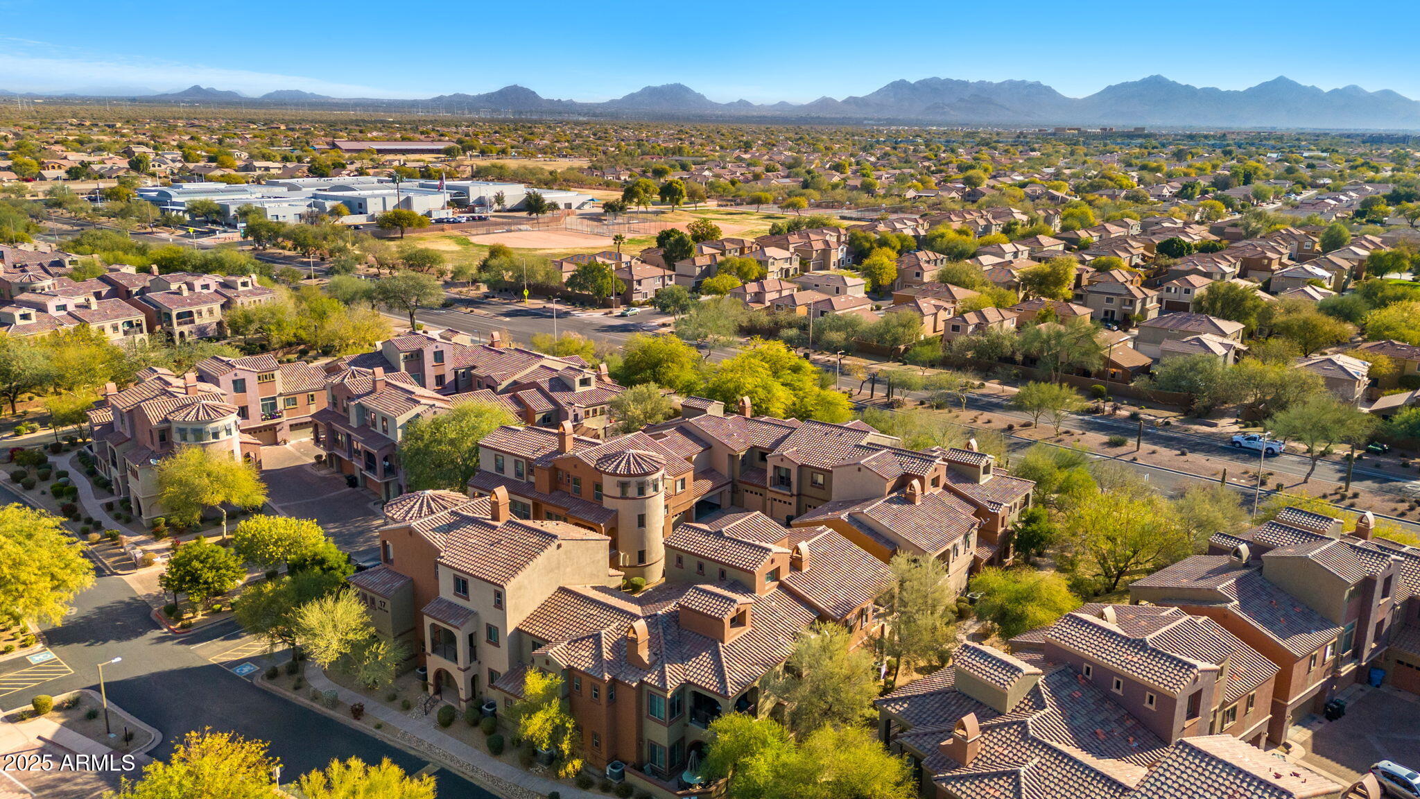 3935 East Rough Rider Road, Unit 1235 Phoenix, AZ 85050 - Photo 51 of 52 an aerial view of residential houses with outdoor space and trees
