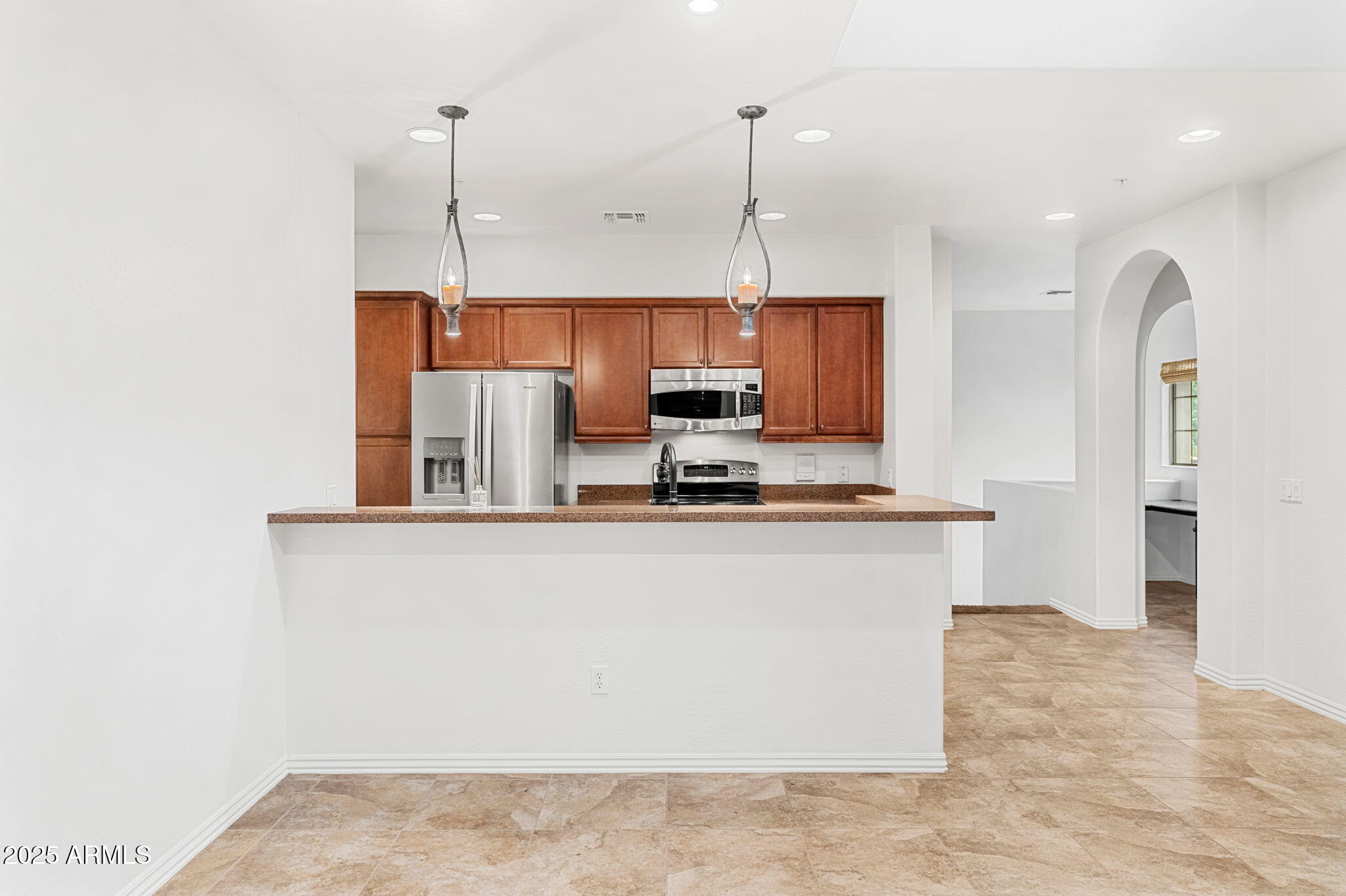 3935 East Rough Rider Road, Unit 1235 Phoenix, AZ 85050 - Photo 9 of 52 a kitchen with stainless steel appliances granite countertop a sink a refrigerator and a granite counter tops