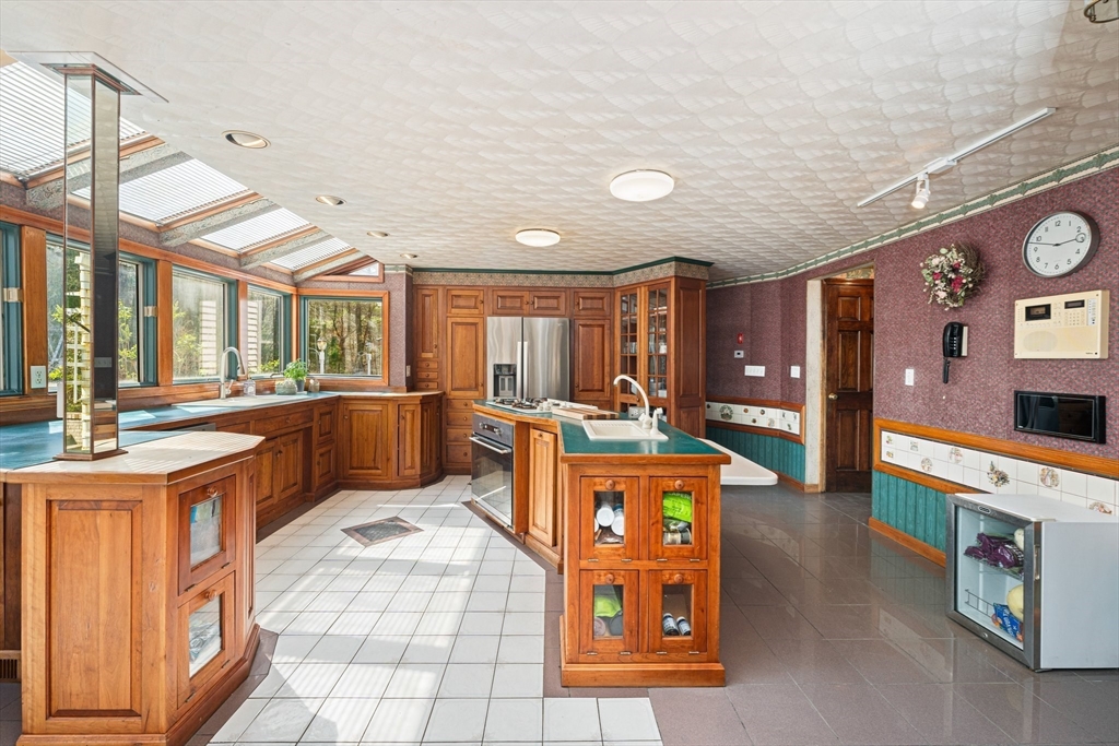 175 Pleasant Street Upton, MA 01568 - Photo 11 of 41 a large living room with stainless steel appliances kitchen island granite countertop a large kitchen view and a sink