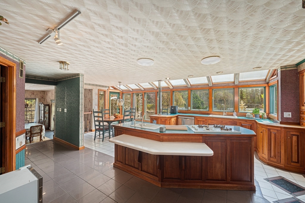 175 Pleasant Street Upton, MA 01568 - Photo 12 of 41 a view of a kitchen with kitchen island a sink and a large window