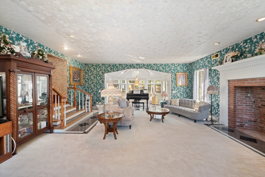 175 Pleasant Street Upton, MA 01568 - Photo 15 of 41 a living room with furniture and a fireplace