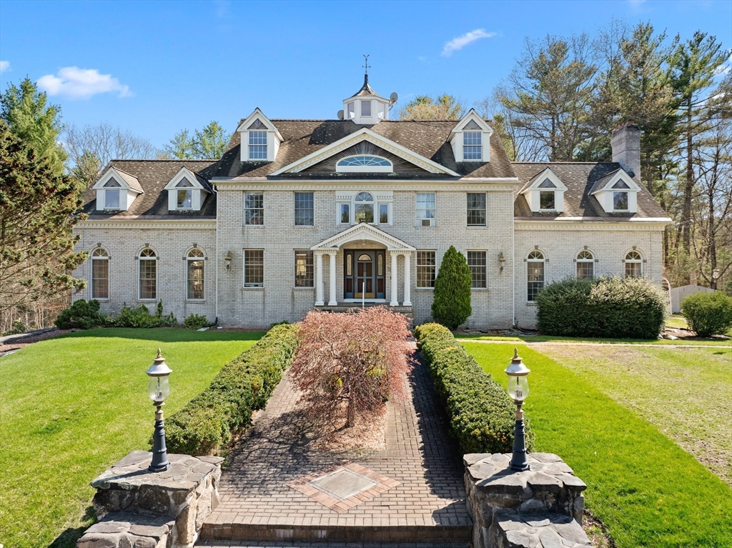 175 Pleasant Street Upton, MA 01568 - Photo 2 of 41 a front view of a house with a yard