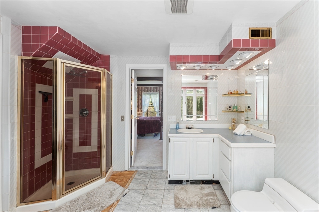 175 Pleasant Street Upton, MA 01568 - Photo 27 of 41 a bathroom with a sink a toilet a mirror and shower