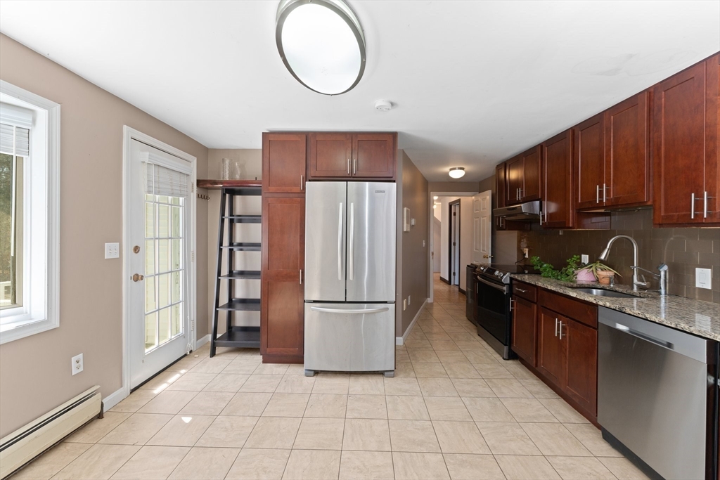 175 Pleasant Street Upton, MA 01568 - Photo 31 of 41 a kitchen with stainless steel appliances granite countertop a refrigerator sink and cabinets