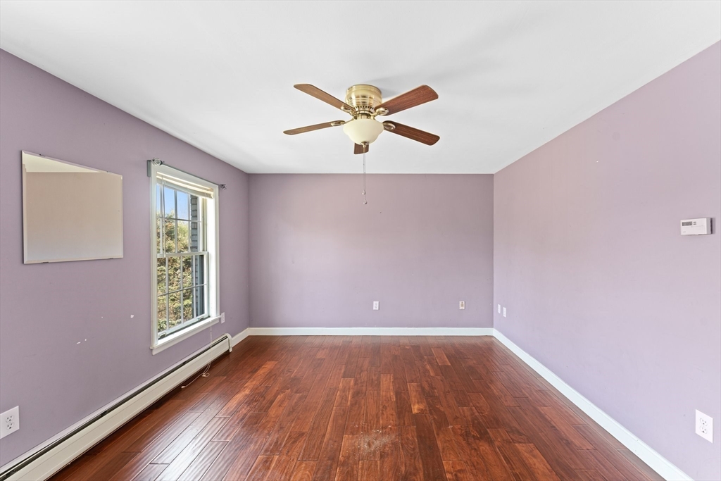 175 Pleasant Street Upton, MA 01568 - Photo 36 of 41 a view of empty room with wooden floor and fan