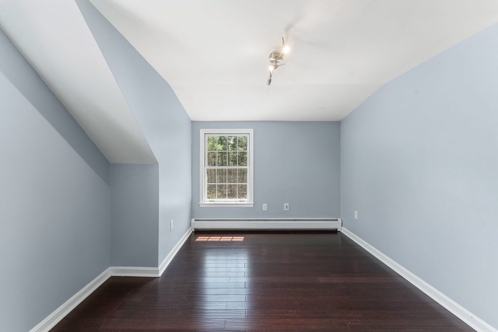 175 Pleasant Street Upton, MA 01568 - Photo 38 of 41 wooden floor in an empty room with a window