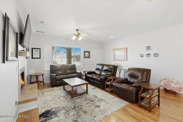 a living room with furniture and wooden floor